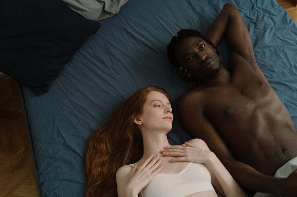 couple lying in bed after intimacy relaxed and connected relationship moment
